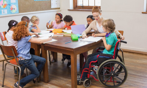 children and teacher at table